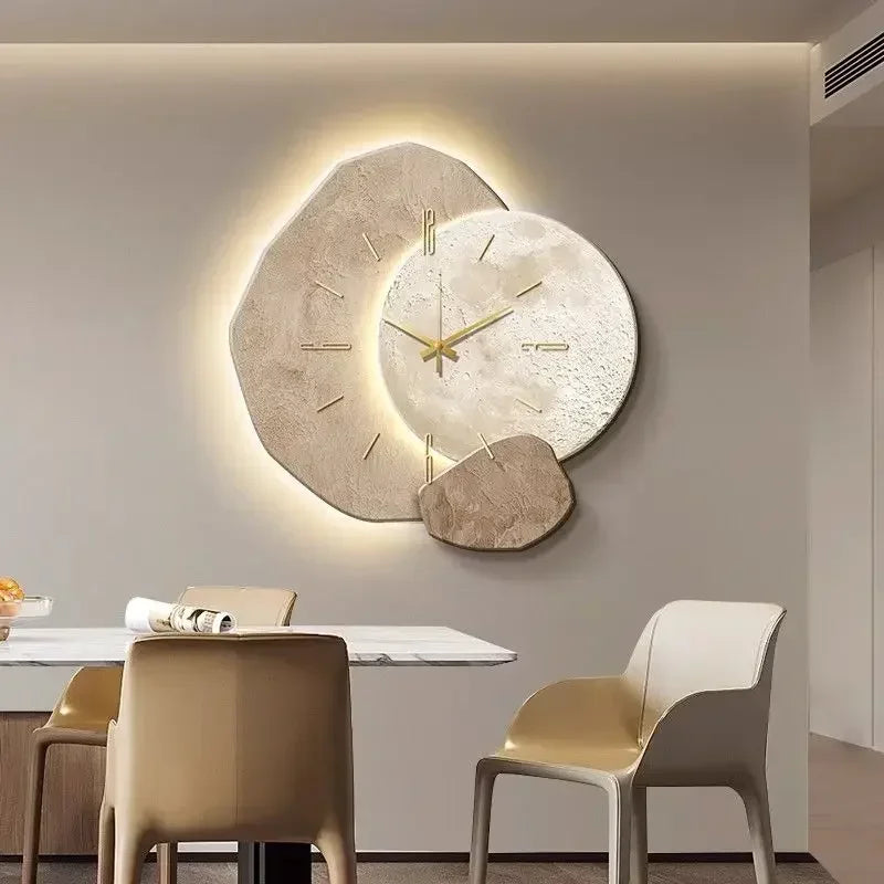 Large backlit LED wall clock with stone-effect face above a dining table